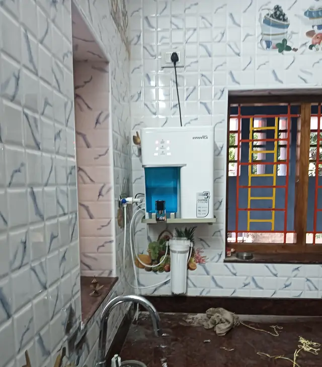 Water purifier mounted above a kitchen sink with a pre-filter