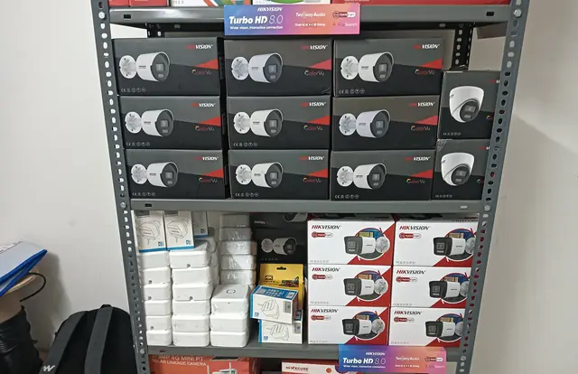 Showroom shelves stacked with boxed Hikvision CCTV cameras