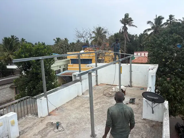 Winzone technician on a rooftop beside a newly built solar panel mounting frame