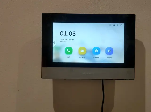 Video door phone indoor touch monitor mounted on a wall